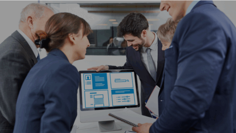 A business team gathered around a computer screen, exploring how a website enhances their marketing strategies.