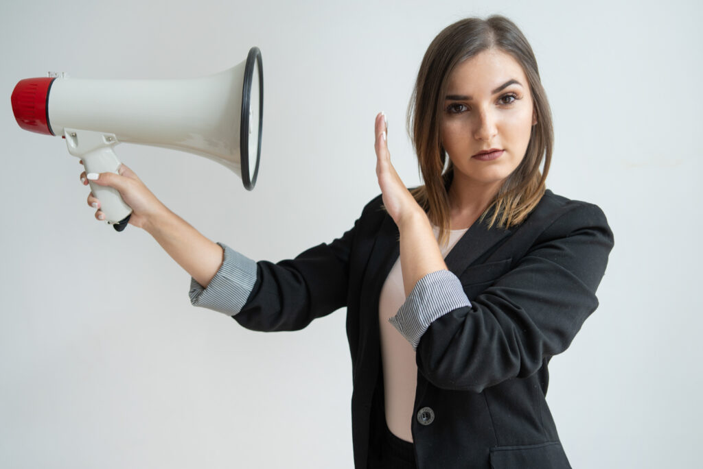 Confident woman rejecting loud announcement with megaphone