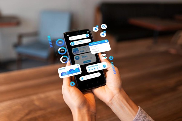 Hands holding a smartphone displaying mobile app UI elements with floating interactive interface icons.